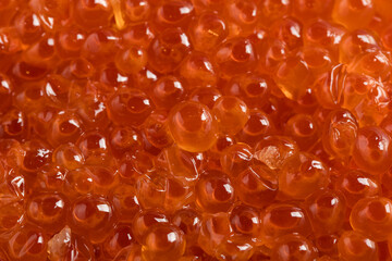 Fresh salmon roe (ikura or salmon caviar) close-up with vibrant orange pearls and glossy texture, ideal for sushi, Japanese cuisine, and premium seafood concepts.