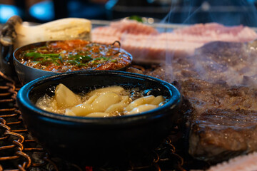 various foods on the charcoal BBQ grill