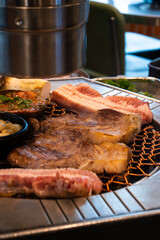 roasting pork belly on charcoal grill in a Korean restaurant