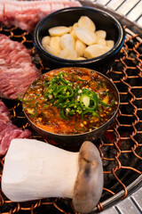 various foods on the charcoal BBQ grill