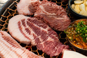 roasting pork belly on charcoal grill in a Korean restaurant
