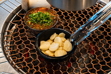various foods on the charcoal BBQ grill
