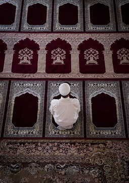 Iranian shiite  prayer sits on a carpet in a mosque, Golestan province, Karim ishan, Iran