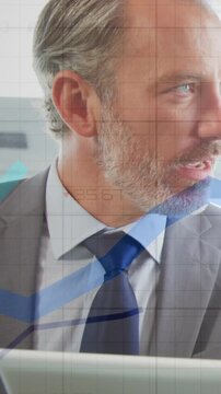 Vertical video: Man looking at laptop and speaking, charts overlaying and showing finance data