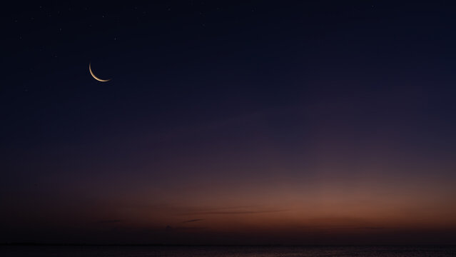 Crescent moon on dusk sky twilight after sundown, religion of Islamic well editing text Ramadan Kareem, Eid al Fitr, Eid Mubarak, Eid Al Adha, Muharram on free space backgrounds