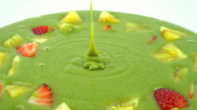 Fresh kiwi slices in vibrant green juice, showcasing a refreshing and healthy fruit concept with natural texture and vibrant color.