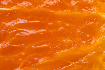 Macro Close-up of Juicy Orange Pulp Texture,A vibrant, high-detail macro shot of fresh orange fruit pulp showing juicy juice vesicles, glistening texture, and bright orange citrus patterns. © banjongseal324