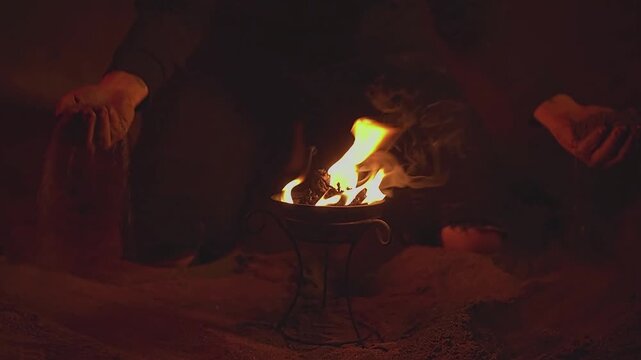 Female fakirs. Woman. Bowl of fire. Sand. Female hands. Night. Slow motion video. . High quality 4k footage