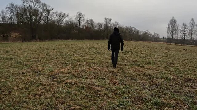 Man Walking Beagle Dog on Leash in Autumn Field Rear View Lifestyle Concept