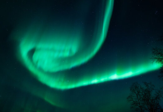 Green aurora spiral seen in Abisko National park in Sweden on a winter night