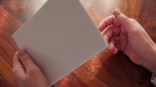 A woman holds an envelope with a letter in her hands before sending it to the post office. She checks the information. High quality 4k footage