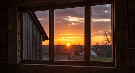 Fototapeta premium Sunset view through a window in a rustic building golden hour landscape