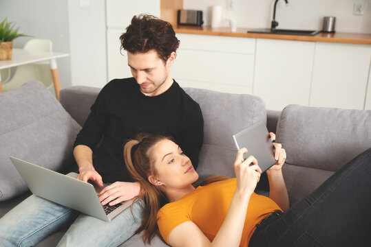 Couple using home internet with mobile devices