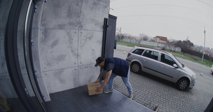 Courier in Silver Car Places Parcel on Porch and Takes Smartphone Photo For Confirmation. Man Then Picks Up Box and Drives Away, Captured by Smart Doorbell Camera. Concept of Evidence Delivery Fraud.