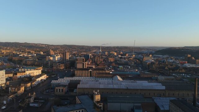 ​Aerial drone shot of Huddersfield town center and St Peter's Church at sunset, West Yorkshire, England.