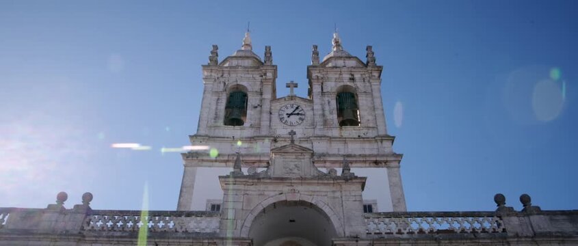 Beautiful sunny day view of the Santu&aacute;rio de Nossa Senhora da Nazar&eacute; in the S&iacute;tio district. This historic white sanctuary stands as a majestic landmark overlooking the city. 