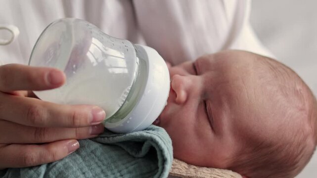 Newborn resting in electric baby swing, sleeping and crying during diaper change, bottle feeding in mother&rsquo;s arms, tiny feet close-up, and medicine drops given gently at home.