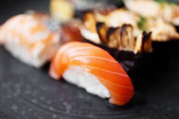 Fresh sushi served on a black plate in a restaurant setting at lunchtime © muse studio