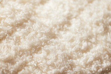 Close-up view of soft, fluffy white fabric texture, showcasing intricate fibers and plush surface ideal for textile design or home decor applications © Dasha Petrenko
