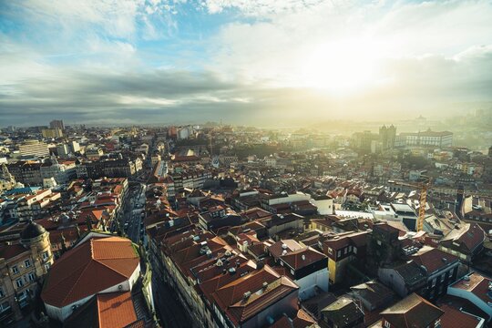 Explore the stunning vistas of Porto as the sun sets over charming rooftops. The Douro River glimmers in the twilight, inviting travelers and locals to connect with authentic Portuguese culture