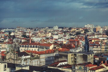 Naklejka premium Feel the charm of Porto with its stunning cityscape featuring traditional rooftops, historic buildings, and the inviting Douro River. A perfect blend of culture and lifestyle awaits