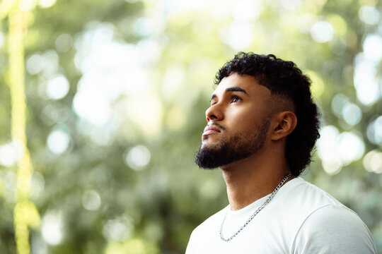 Young man looking up with thoughtful expression
