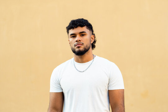 Young man with serious expression looking at camera