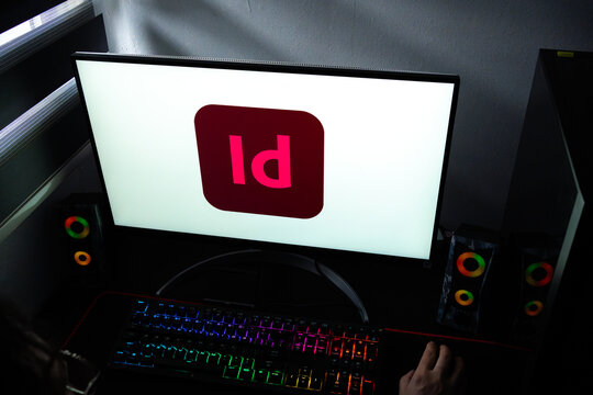 Punta Arenas, Chile &ndash; February 17, 2026: A person working at a desk with the Adobe InDesign logo displayed on a computer monitor