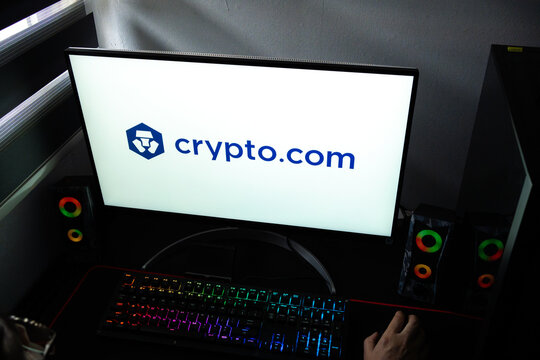 Punta Arenas, Chile &ndash; February 18, 2026: A person at a desk with the Crypto.com (CRO) exchange logo displayed on a computer monitor
