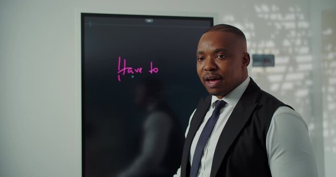 Teacher explaining English grammar on digital board