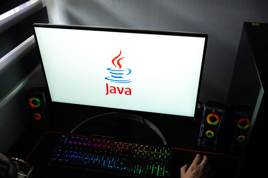 Punta Arenas, Chile &ndash; February 18, 2026: A person at a desk with the Java programming language and computing platform logo displayed on a computer monitor