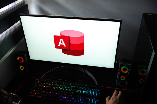 Punta Arenas, Chile &ndash; February 18, 2026: A person at a desk with the Microsoft Access database management software logo displayed on a computer monitor