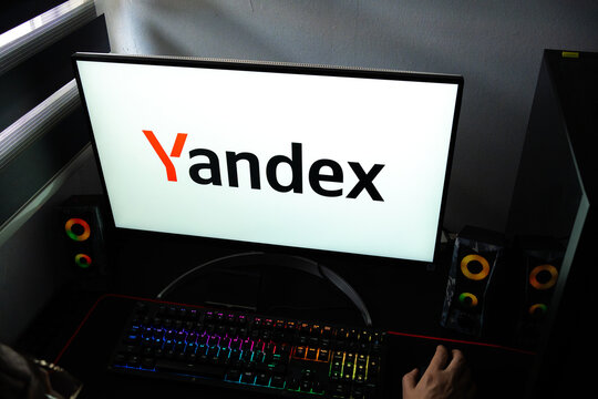 Punta Arenas, Chile &ndash; February 18, 2026: A person at a desk with the Yandex search engine and digital ecosystem logo displayed on a computer monitor