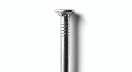 Close-up of a shiny metal nail, showing its head and shank. On a white background, this hardware item symbolizes strength and precision for construction