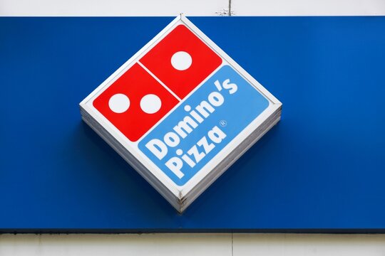 Saint-Etienne, France - June 21, 2020: Domino's pizza logo on a wall of a restaurant. Domino's pizza is an American pizza restaurant chain founded in 1960