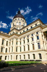Kansas State Capitol building in Topeka. Historic French Renaissance Revival government architecture features a limestone facade and a prominent dome with the Ad Astra statue under a blue sky