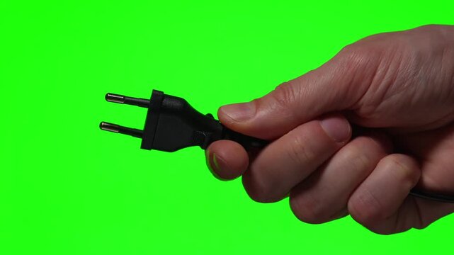 A close-up of a 200-volt electrical plug against a green background.
Connecting electrical equipment.
Charging device for household appliances in the home.
