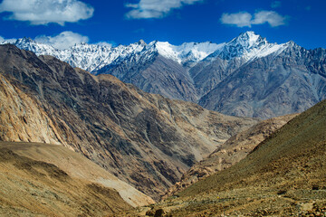Snowy Himalayan peaks, blue sky at Chang La,southern pass, high mountain pass in Ladakh in the Greater Himalaya between Leh and the Shyok River valley. Leh to Pangong Lake road. Leh, Ladakh, India.