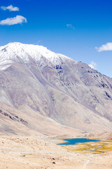 View of lake and river with snowy mountain peak at Chang La , southern pass, a high mountain pass in Ladakh in the Greater Himalaya between Leh and the Shyok River valley. Leh, Ladakh, India.