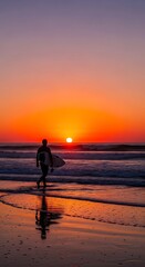Fototapeta premium Man walking on beach at sunset.