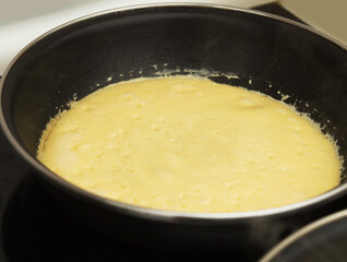 making very thin pancakes with Choux pastry, bubbly lacy texture 
