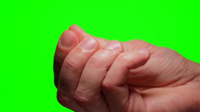 Nails on a man's hand against a green background.
Close-up of a man's hand manicure with a chroma key.
Nails against a chroma key background for background replacement.