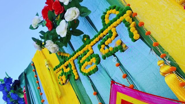 Traditional Mehndi Ceremony Stage Decor with Floral Garlands and Bright Colors