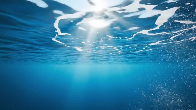 Underwater view with sunlight shining through the surface and bubbles rising to the top of the ocean