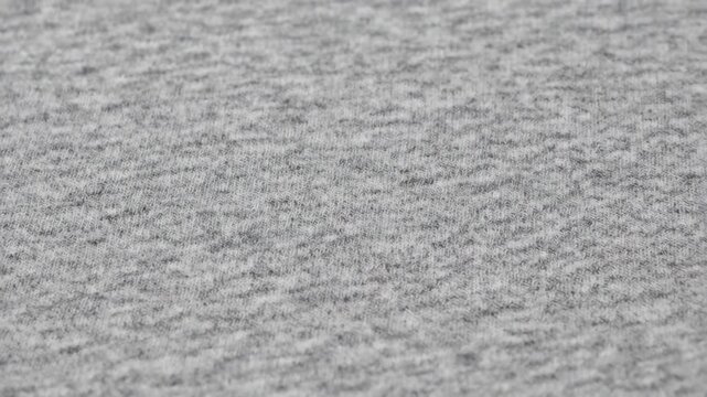 Soft gray heather cotton fabric texture in a detailed macro view. Neutral melange textile surface for apparel manufacturing concepts or a simple abstract background for design