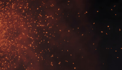 Glowing orange particles on dark background with smoke effect