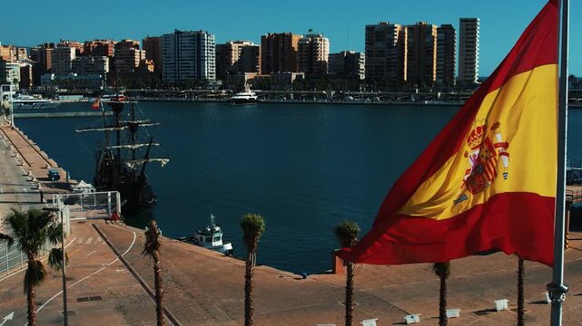 Aerial Madrid city business center. Flag waving high above the city. Breathtaking view of Spain. Drone bird eye view. Barcelona panoramic landscape. Sunny summer day. Concept of travel, city life