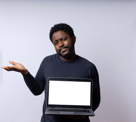 Black Brazilian man with a laptop against a neutral white background.
