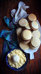 Homemade pancakes with creamy dessert and powdered sugar top view