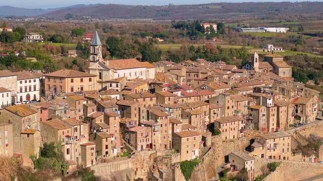 Aerial view of Grotte di Castro hilltop village on tuff cliff. Cinematic panorama of authentic Italian town, hidden gems of Italy, Lazio. 4K 10-bit HDR drone footage. Most beautiful Italian villages.